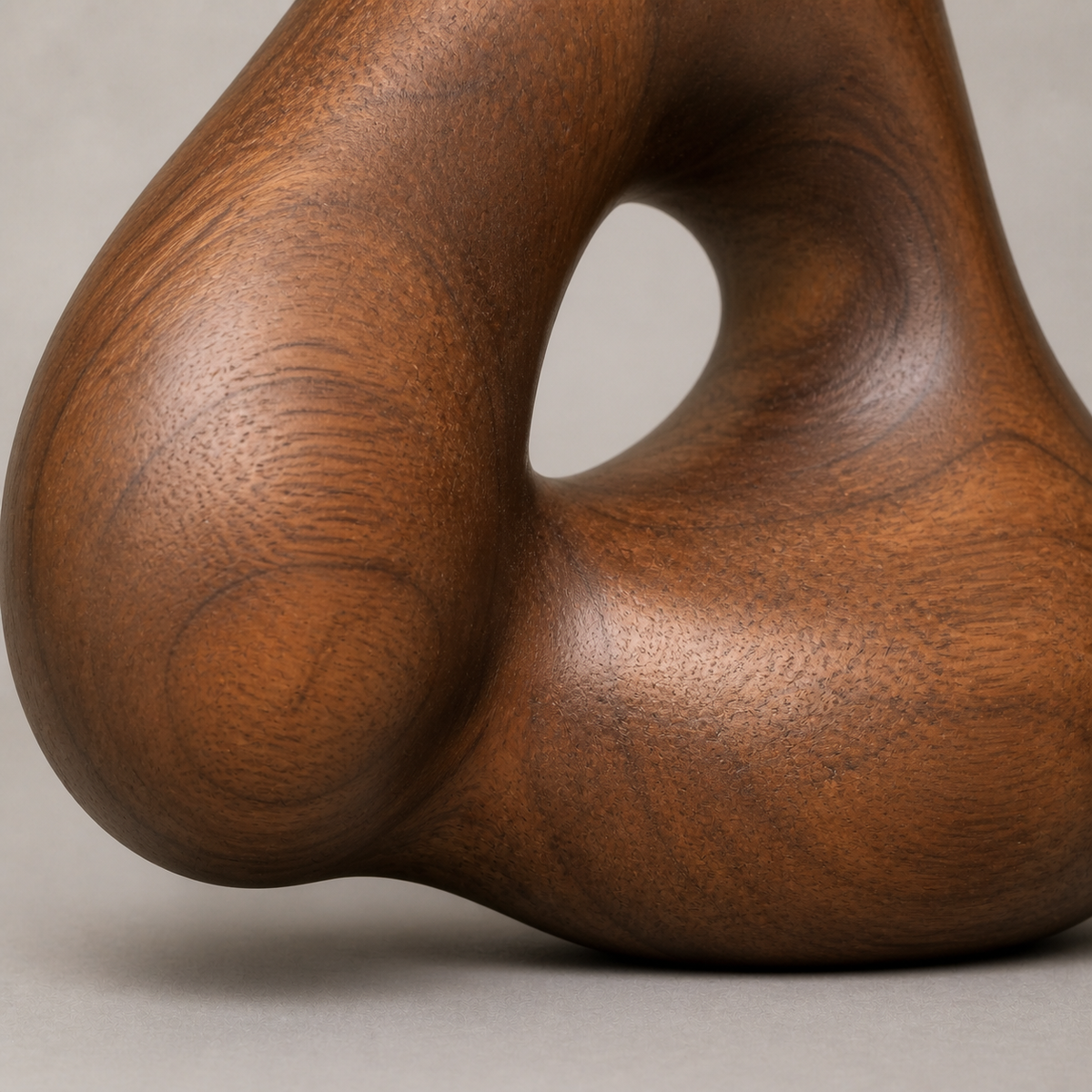 Knotted Aperture, teak wood tabletop sculpture — wood grain and carved detail