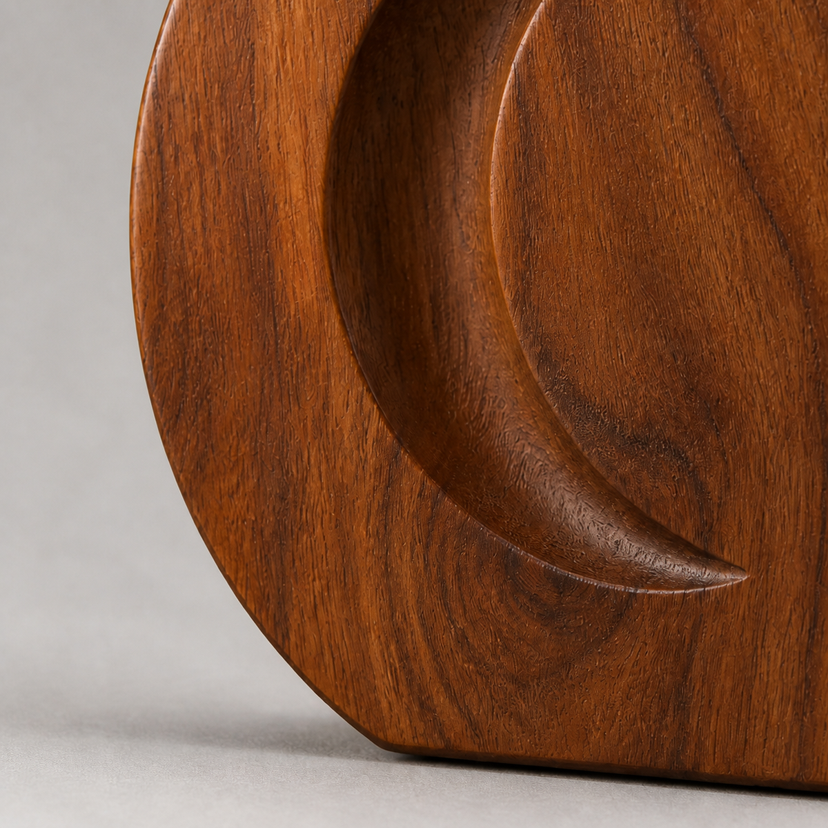 Crescent Token, teak wood tabletop sculpture — wood grain and carved detail