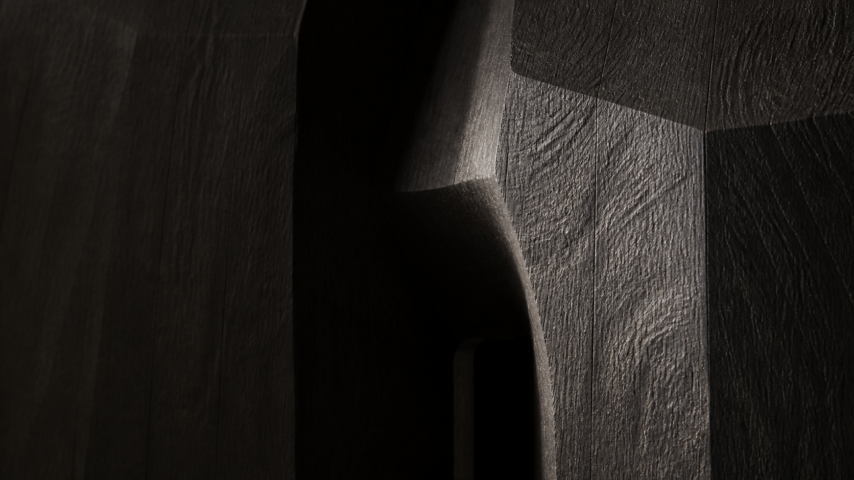 Close view of ebonized teak carving and grain