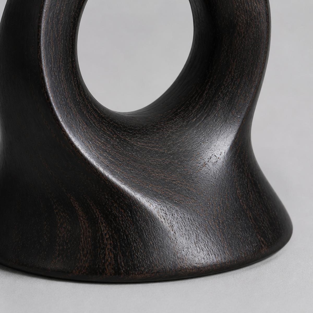 Rooted Loop, teak wood tabletop sculpture — wood grain and carved detail