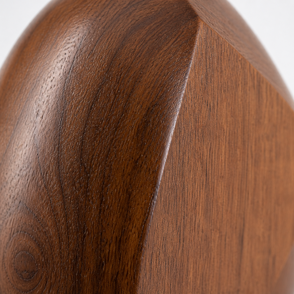 Facet Seed, teak wood tabletop sculpture — wood grain and carved detail