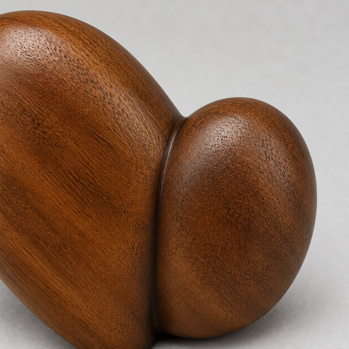 Twin Pebble, teak wood tabletop sculpture — wood grain and carved detail