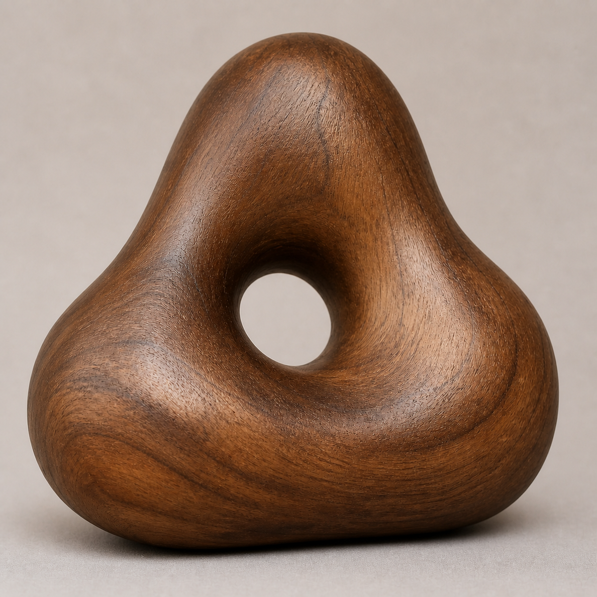 Knotted Aperture, teak wood tabletop sculpture — wood grain and carved detail
