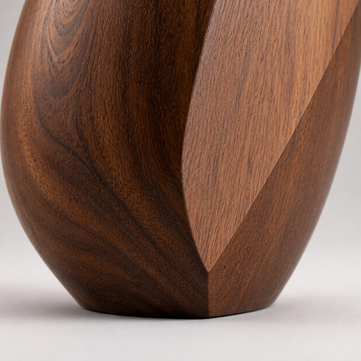 Facet Seed, teak wood tabletop sculpture — wood grain and carved detail