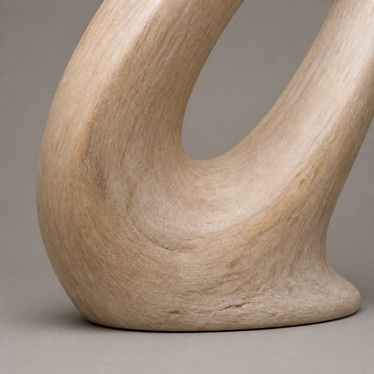 Oblique Halo, abstract teak wood sculpture — wood grain and carved detail