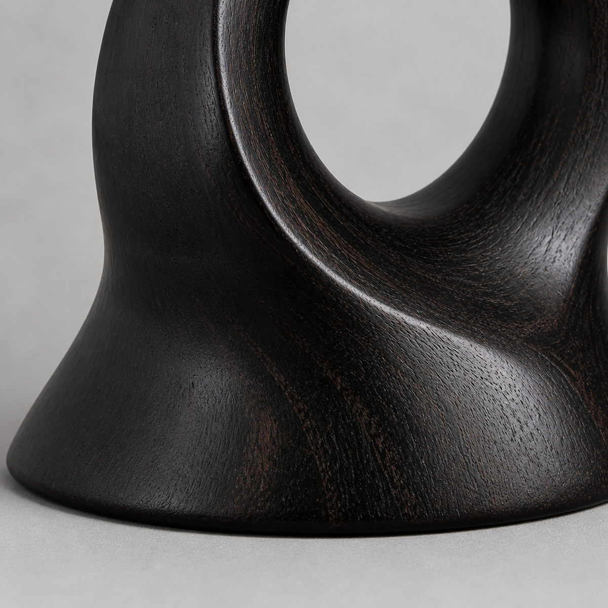 Rooted Loop, teak wood tabletop sculpture — wood grain and carved detail