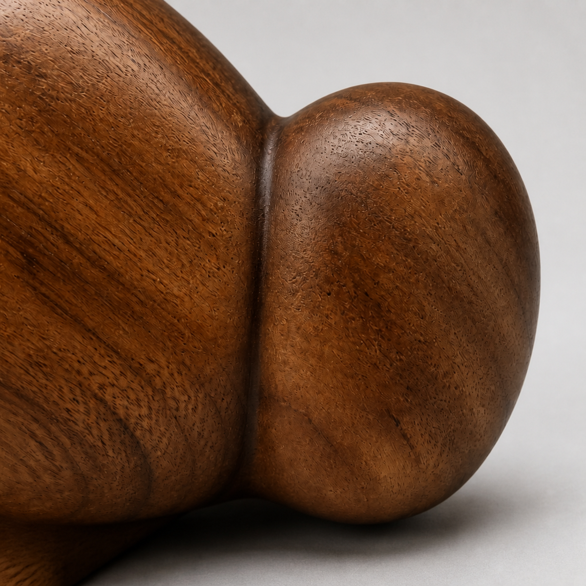 Twin Pebble, teak wood tabletop sculpture — wood grain and carved detail
